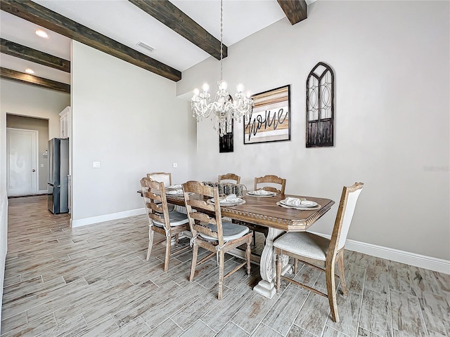 dining space featuring beamed ceiling and an inviting chandelier