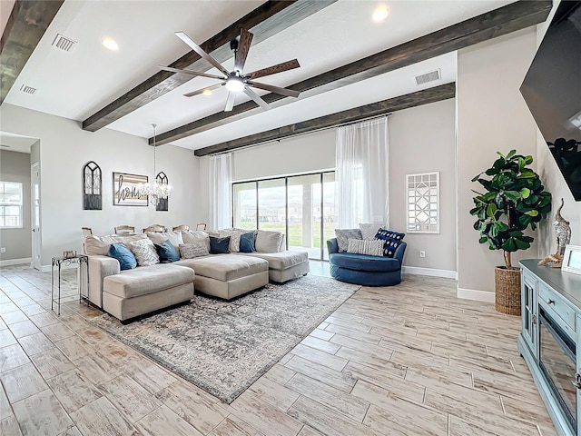 living room featuring ceiling fan with notable chandelier and beam ceiling