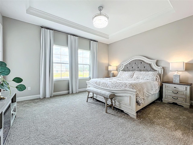 carpeted bedroom featuring ornamental molding, a raised ceiling, and a chandelier