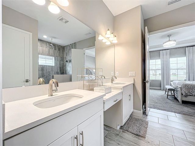 bathroom featuring vanity and tiled shower