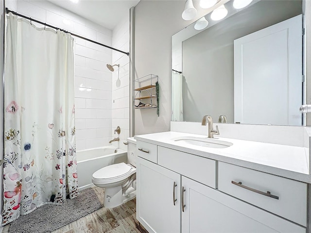 full bathroom with shower / bath combo with shower curtain, wood-type flooring, toilet, and vanity