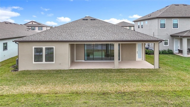 rear view of house with a yard and a patio