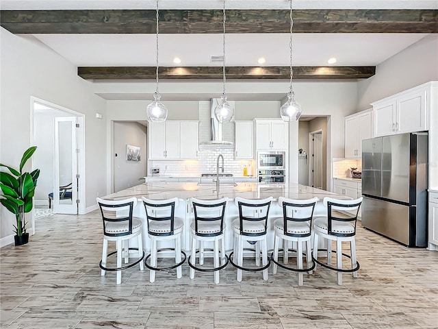 kitchen with a large island, hanging light fixtures, and stainless steel appliances