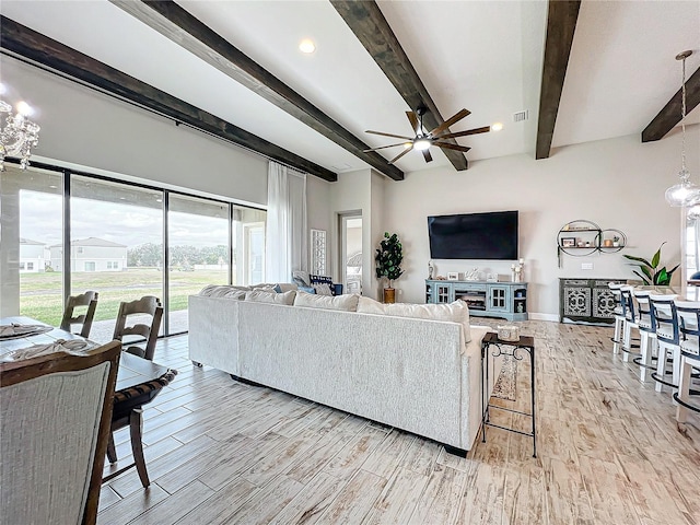 living room featuring ceiling fan and beam ceiling