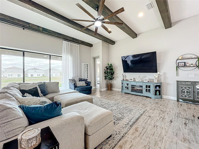 living room with hardwood / wood-style flooring, beamed ceiling, and ceiling fan