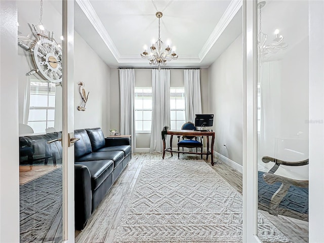 interior space featuring ornamental molding, a raised ceiling, and a notable chandelier