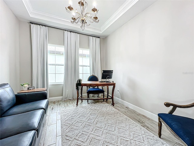 home office with a raised ceiling, a notable chandelier, and light wood-type flooring