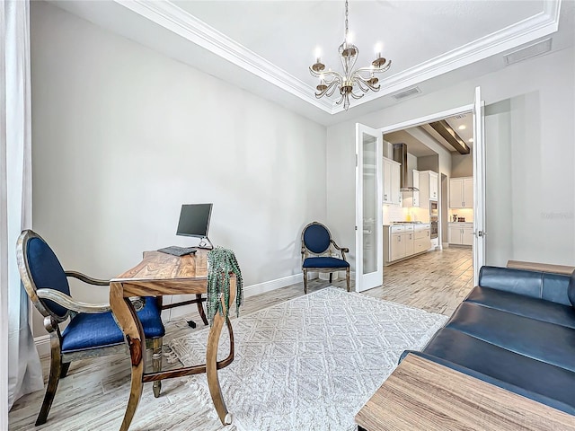 office area with ornamental molding, light hardwood / wood-style floors, and an inviting chandelier