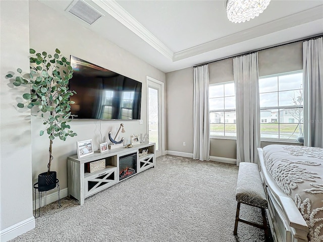 carpeted bedroom featuring crown molding and a raised ceiling