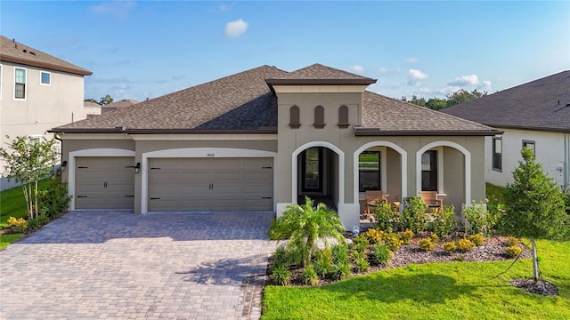 13028 Homestead Ln, Parrish, FL 34219 - mediterranean / spanish home featuring stucco siding, a shingled roof, and a garage