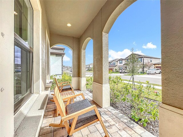 13028 Homestead Ln, Parrish, FL 34219 - view of patio featuring covered porch and a residential view