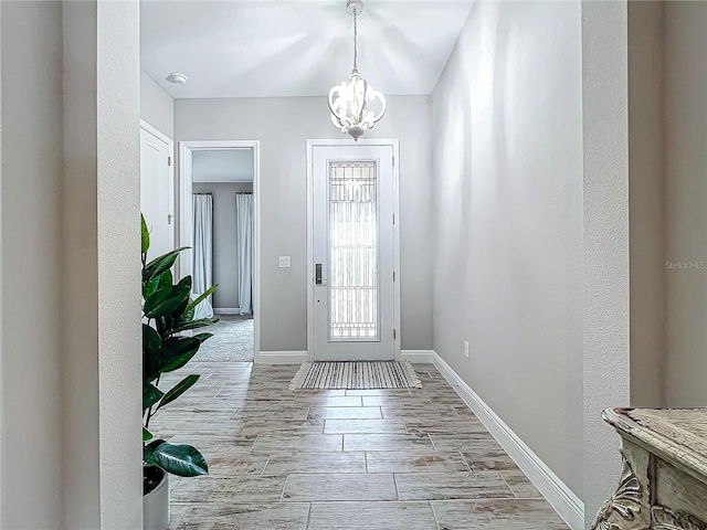 13028 Homestead Ln, Parrish, FL 34219 - foyer with a chandelier, baseboards, and wood tiled floors