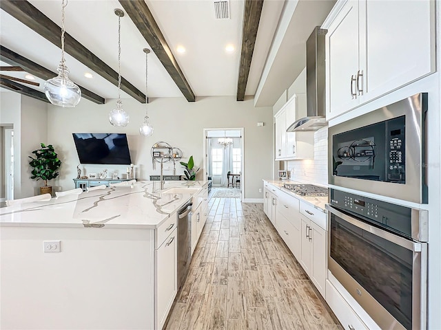 13028 Homestead Ln, Parrish, FL 34219 - kitchen featuring stainless steel appliances, wall chimney range hood, light wood-style flooring, beamed ceiling, and white cabinets