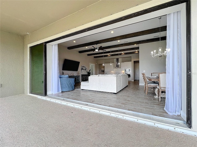 13028 Homestead Ln, Parrish, FL 34219 - living area featuring beam ceiling, a chandelier, ceiling fan, and baseboards