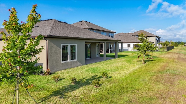 13028 Homestead Ln, Parrish, FL 34219 - back of house featuring stucco siding and a patio