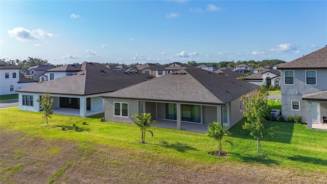 13028 Homestead Ln, Parrish, FL 34219 - back of house featuring a residential view and a yard