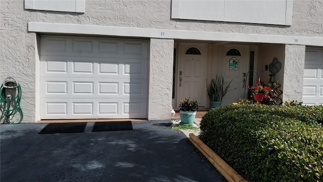 view of exterior entry with a garage