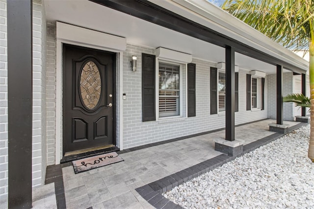 doorway to property featuring covered porch