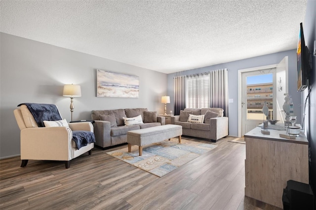 living room with hardwood / wood-style floors and a textured ceiling