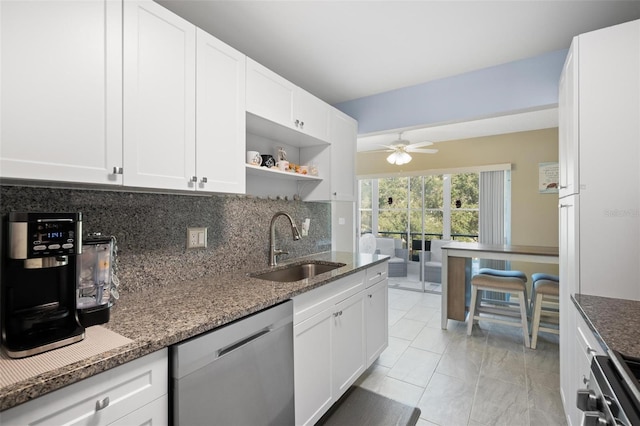 kitchen with backsplash, dark stone counters, sink, dishwasher, and white cabinetry