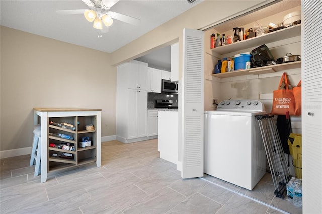 clothes washing area featuring ceiling fan and washer / dryer