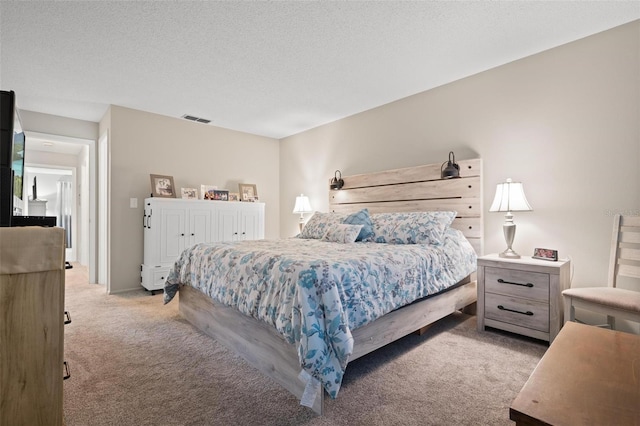 bedroom with light carpet and a textured ceiling