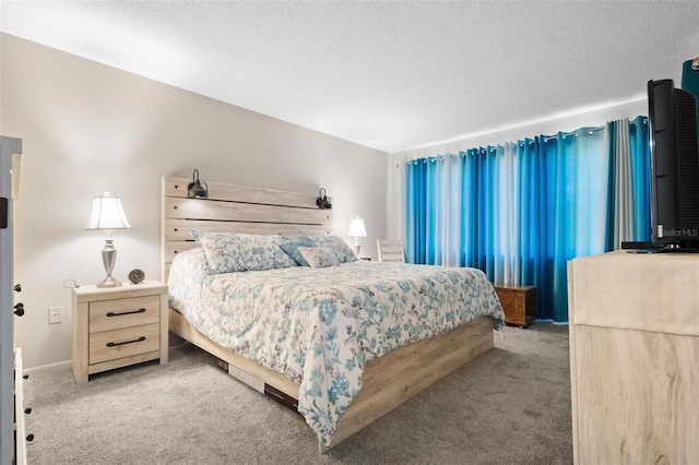 carpeted bedroom featuring a textured ceiling