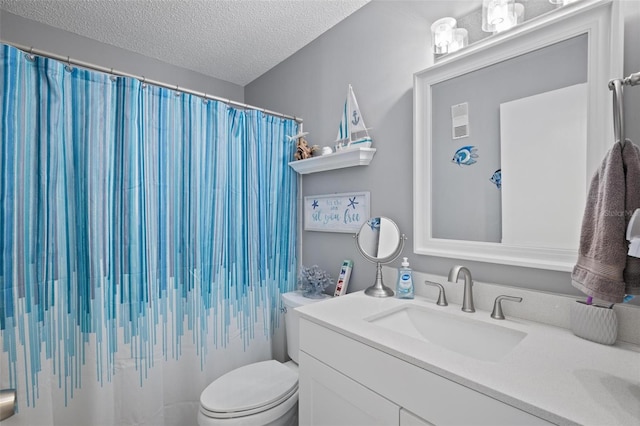 bathroom with vanity, toilet, and a textured ceiling