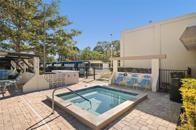 view of swimming pool featuring a community hot tub and a patio area