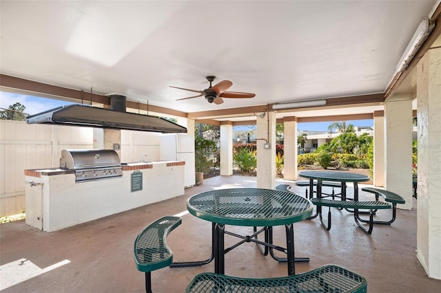 view of patio featuring ceiling fan, a grill, exterior kitchen, and sink