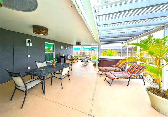 view of patio / terrace with a hot tub, outdoor dining area, and a fenced backyard