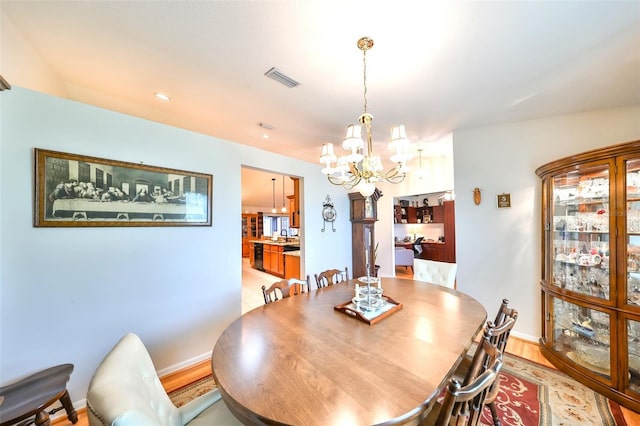 dining area with visible vents, baseboards, and a chandelier