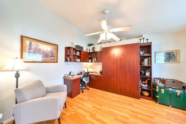 office area featuring built in study area, light wood-type flooring, a ceiling fan, and vaulted ceiling