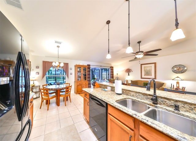 kitchen with light tile patterned floors, visible vents, a sink, black appliances, and open floor plan