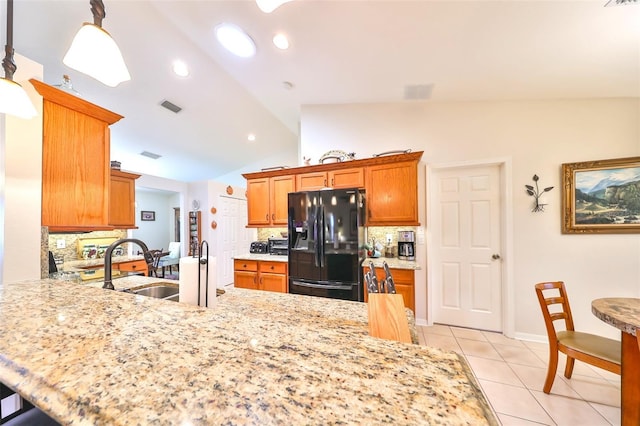 kitchen with visible vents, black fridge with ice dispenser, light tile patterned floors, decorative backsplash, and vaulted ceiling