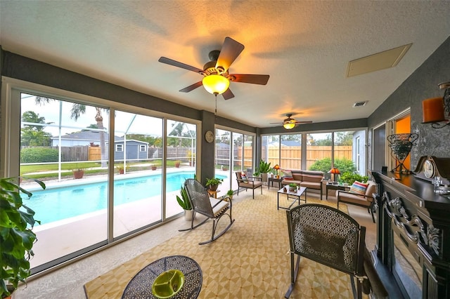 sunroom / solarium with visible vents and a ceiling fan