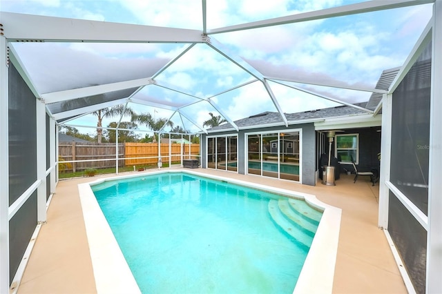 view of swimming pool with a patio area, a fenced backyard, a fenced in pool, and a lanai