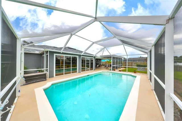 outdoor pool featuring a lanai and a patio area