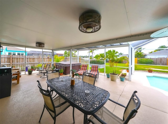 view of patio with a fenced backyard, glass enclosure, outdoor dining area, a fenced in pool, and a hot tub