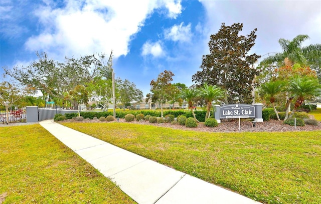 view of property's community featuring a yard and fence