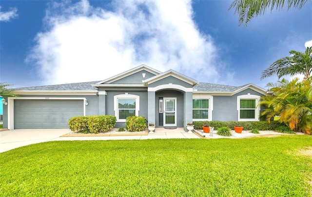 ranch-style house with stucco siding, concrete driveway, a front yard, and a garage