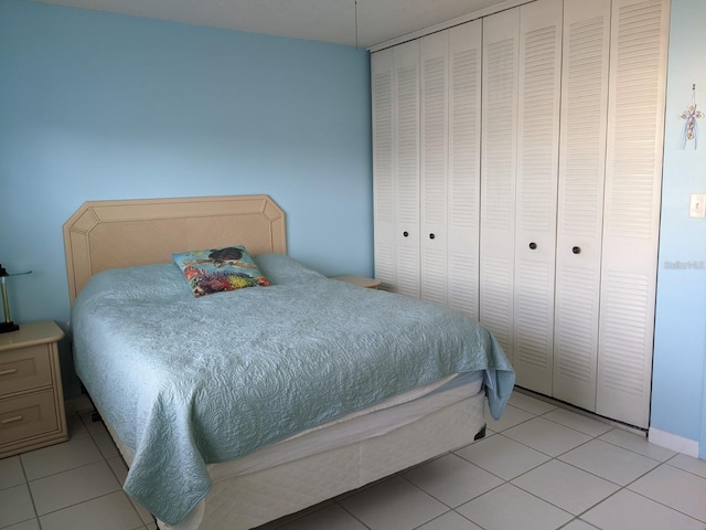 bedroom with a closet and light tile patterned floors