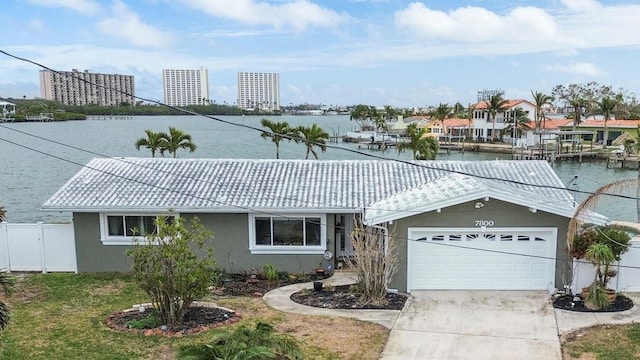 single story home featuring a garage and a water view