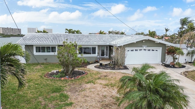 ranch-style home featuring a garage and a front lawn