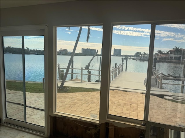 doorway to outside featuring a water view and tile patterned floors