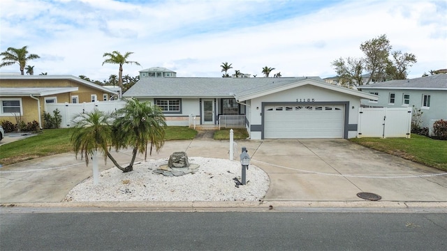 single story home with a front yard and a garage