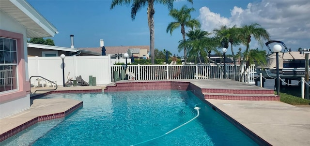 view of swimming pool featuring pool water feature and a patio area