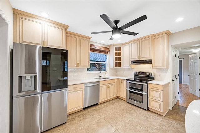 kitchen with sink, ceiling fan, decorative backsplash, light brown cabinetry, and stainless steel appliances