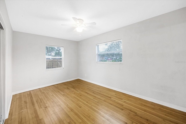 unfurnished room featuring ceiling fan, light hardwood / wood-style floors, and a wealth of natural light