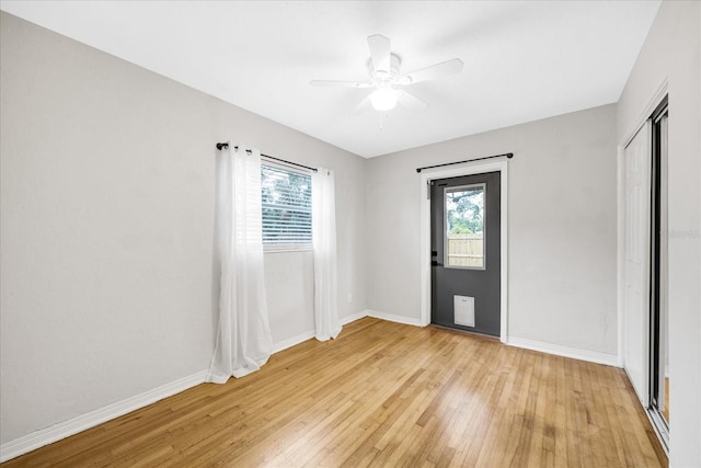 spare room with light hardwood / wood-style flooring, plenty of natural light, and ceiling fan